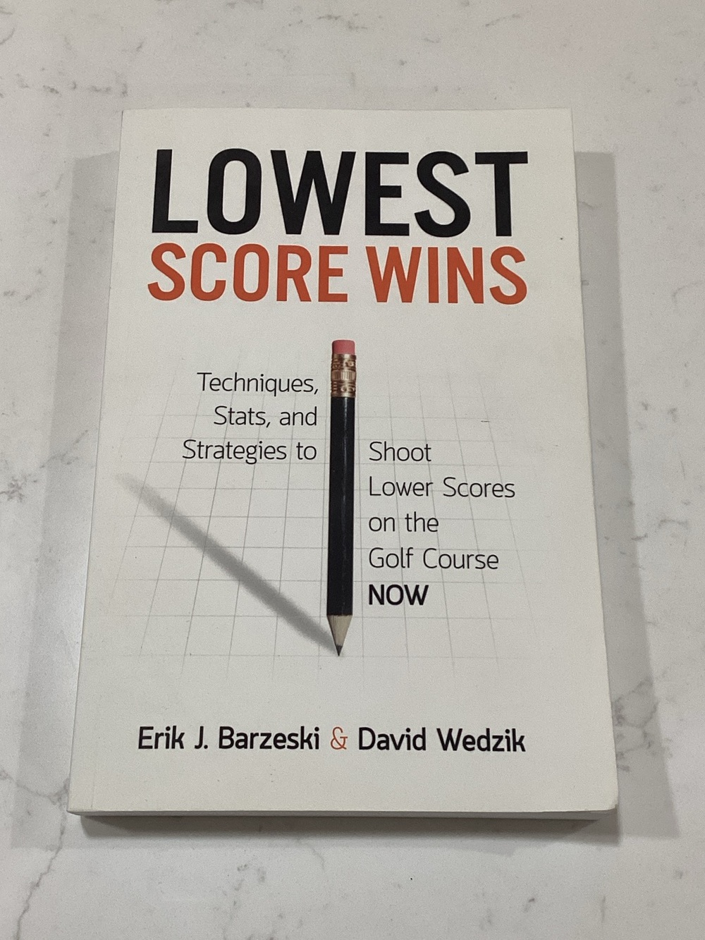 Lowest Score Wins Paperback - White Cover with Black & Orange Text
